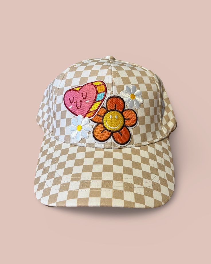 Upgrade your spring and summer style with our Flower Power Checked Cap. This white and tan checkered baseball cap features floral and heart patches for a playful yet stylish look. Get ready to rock your flower power vibes with this quirky and fun accessory! A Cactus Jane Original, made in house at our Laguna Beach store front Trendy Spring Hats With Curved Visor, Trendy Spring Hat With Curved Visor, Trendy Curved Visor Hats For Spring, Retro Spring Baseball Cap With Curved Brim, Retro Curved Brim Baseball Cap For Spring, Retro Visor Hats For Spring, Cute Spring Cotton Baseball Cap, Cute Cotton Baseball Cap For Spring, Trendy Spring Baseball Cap With Curved Visor