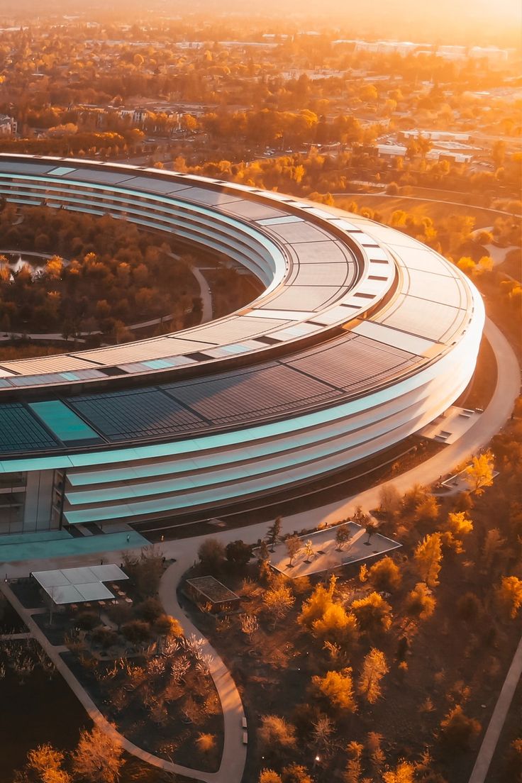 an aerial view of a circular building surrounded by trees