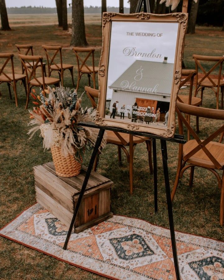 a sign that is on top of a wooden box and some chairs in the background