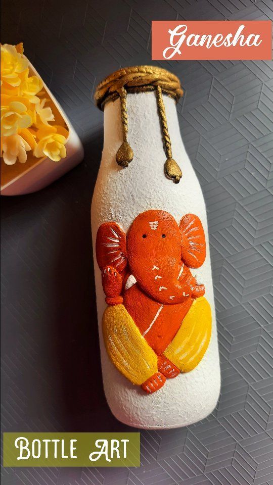 a bottle with an elephant painted on it next to a bowl of macaroni and cheese