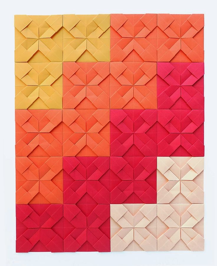 an orange, yellow and red pattern made out of paper