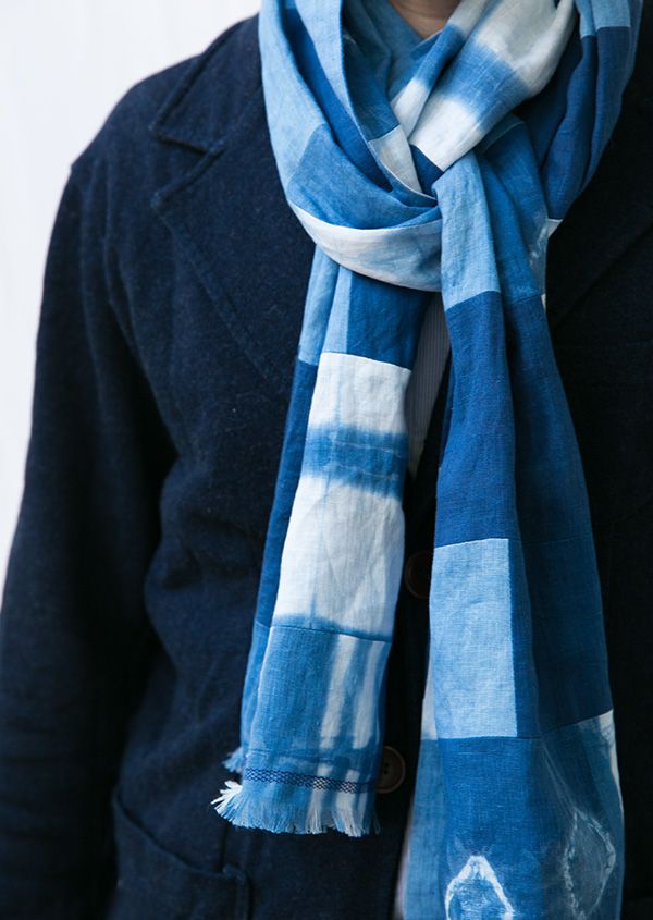 a woman wearing a blue and white scarf