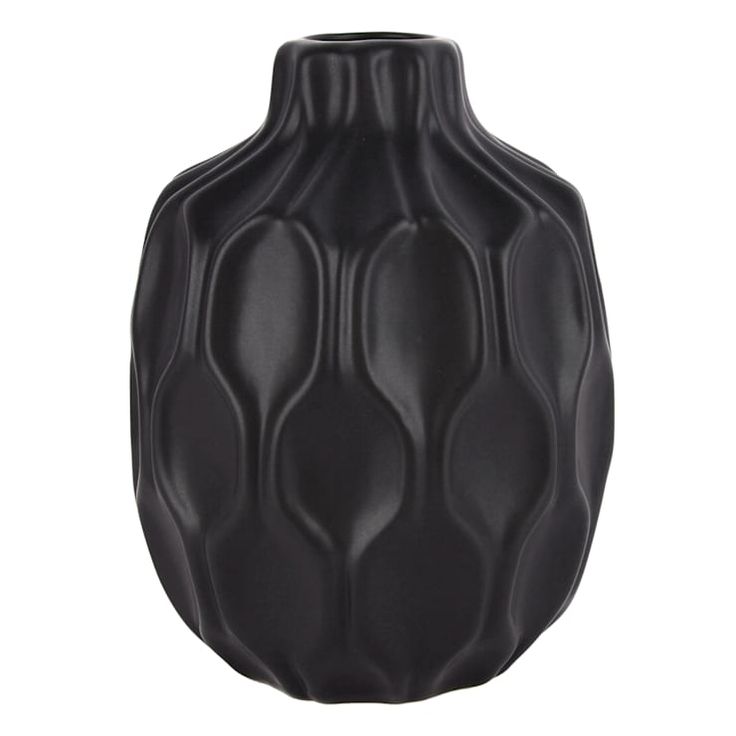 a black vase sitting on top of a white table