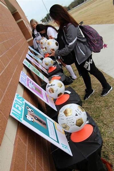 several people are lined up with soccer balls