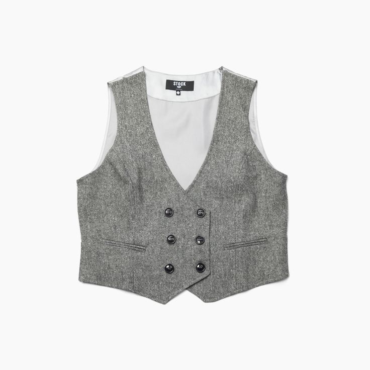 Ever want to wear a jacket, but not commit to sleeves? Enter the Service Vest. These high quality vests add a polished look to any service industry employee, whether you're serving up sushi omakase or mixing a Corpse Reviver No. 2 behind the bar. They feature a tailored fit with built-in stretch, adjustable satin back, functional pockets, and a button front. Features: Double Breasted Front Button Closure, Dual Faux-Pockets, Adjustable Cinch Back. Material: Self: 56% Wool, 20% Polyester, 17% Visc Tweed Vest For Workwear In Fall, Tweed Business Vest For Fall, Business Tweed Vest For Fall, Fall Business Tweed Vest, Classic Gray Vest For Work, Elegant Tweed Vest For Work, Elegant Tweed Workwear Vest, Elegant Tweed Work Vest, Classic Tweed Vest For Work