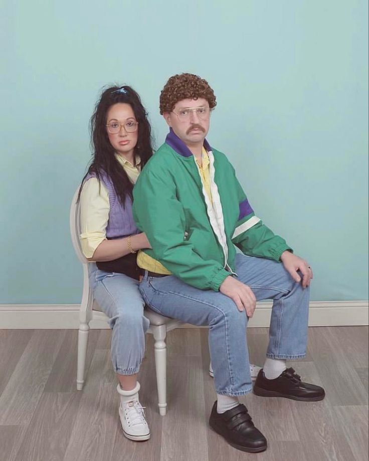 a man and woman are sitting on a chair