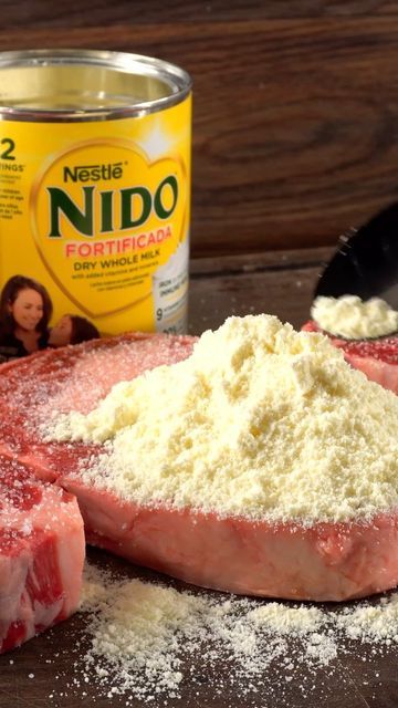 raw meat and powdered sugar on a wooden table next to a can of nido