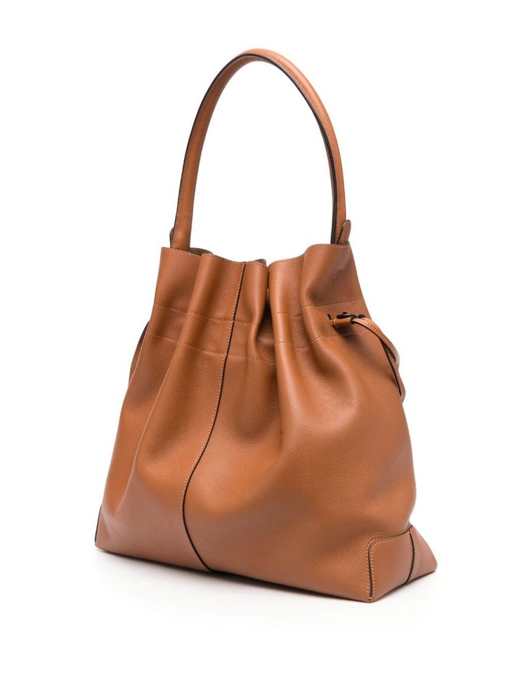 logo-patch leather bucket bag from TOD'S featuring brown, leather, logo patch to the front, internal logo stamp, drawstring fastening, single top handle, main compartment and removable pouch. Size Info UNI Color Detail Leather Brown Made In Italy Material Exterior: 100% calf leather Season One Fall-Winter Season Two Fall-Winter Product bags.. Brand Tod'S Size And Fit Width 13,78 in / 35 cm Height 13,78 in / 35 cm Depth 5,91 in / 15 cm Handle 6,69 in / 17 cm Designer Bucket Hobo Bag, Designer Everyday Bucket Bag, Designer Brown Bucket Bag With Removable Pouch, Designer Brown Bucket Shoulder Bag, Designer Bucket Hobo Bag With Removable Pouch, Designer Hobo Bucket Bag With Removable Pouch, Designer Brown Bucket Bag For Travel, Designer Everyday Bucket Satchel Bag, Luxury Bucket Shape Hobo Bag For Errands