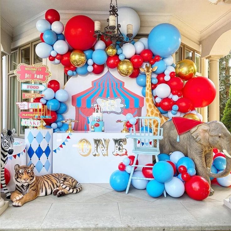 an elephant, zebra and giraffe themed birthday party with red, white, and blue balloons