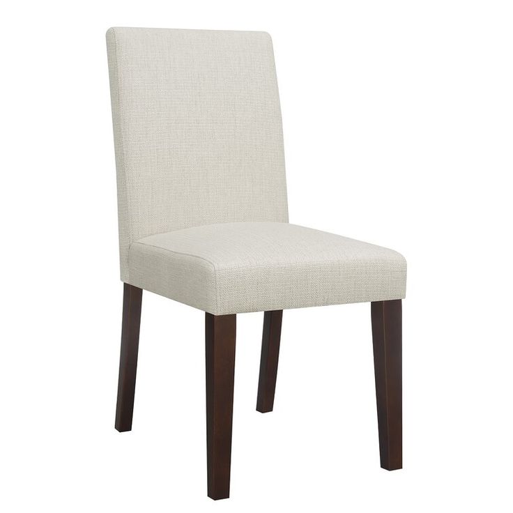 a white upholstered chair with dark wood legs