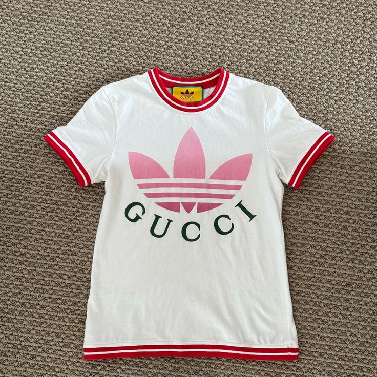 This Is An Authentic Gucci X Adidas Collaboration Tee. Worn Once Comes With Original Packaging Purchased Directly From Gucci Summer Tops With Logo Detail, Summer Fitted Gucci Tops, White Sporty Gucci Top, Sporty White Gucci Tops, Summer Monogram Print Tops, Designer Fitted Tops With Logo Print, Gucci White Crew Neck Top, White Gucci Crew Neck Top, Luxury White Top With Monogram Print