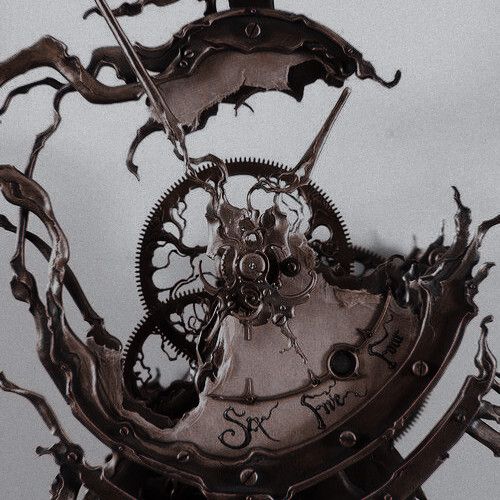 an old clock with gears attached to it's sides is shown in black and white