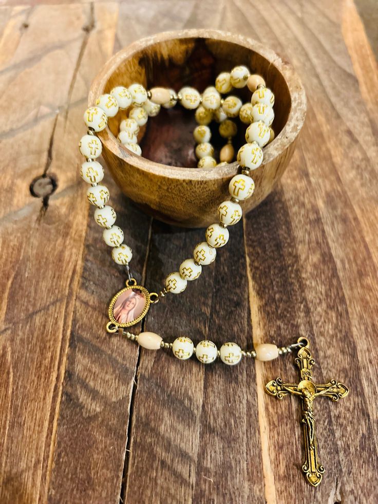 Handmade beaded rosary with 6mm cross emblem beads.  Our Lady of Fatima centerpiece with gold crucifix. Gold Rosary Bracelet With Cross And 8mm Beads, Gold Beaded Rosary Bracelet With Cross Shape, Gold Beaded Crucifix Rosary, Gold Spiritual Rosary With Round Beads, Spiritual Gold Rosary With 8mm Beads, Gold Handmade Cross Rosary Bracelet, Vintage Gold Rosary With Crucifix, Adjustable Crucifix Rosary, Spiritual Beaded Rosary Bracelet With Crucifix