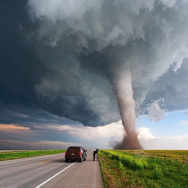 a large tornado is coming down the road