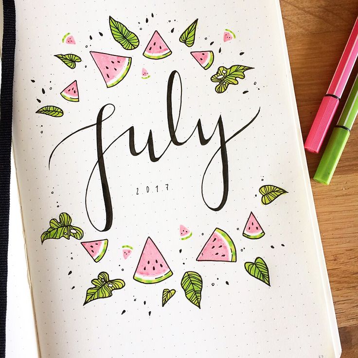 a notebook with the word july written in cursive writing and watermelon slices