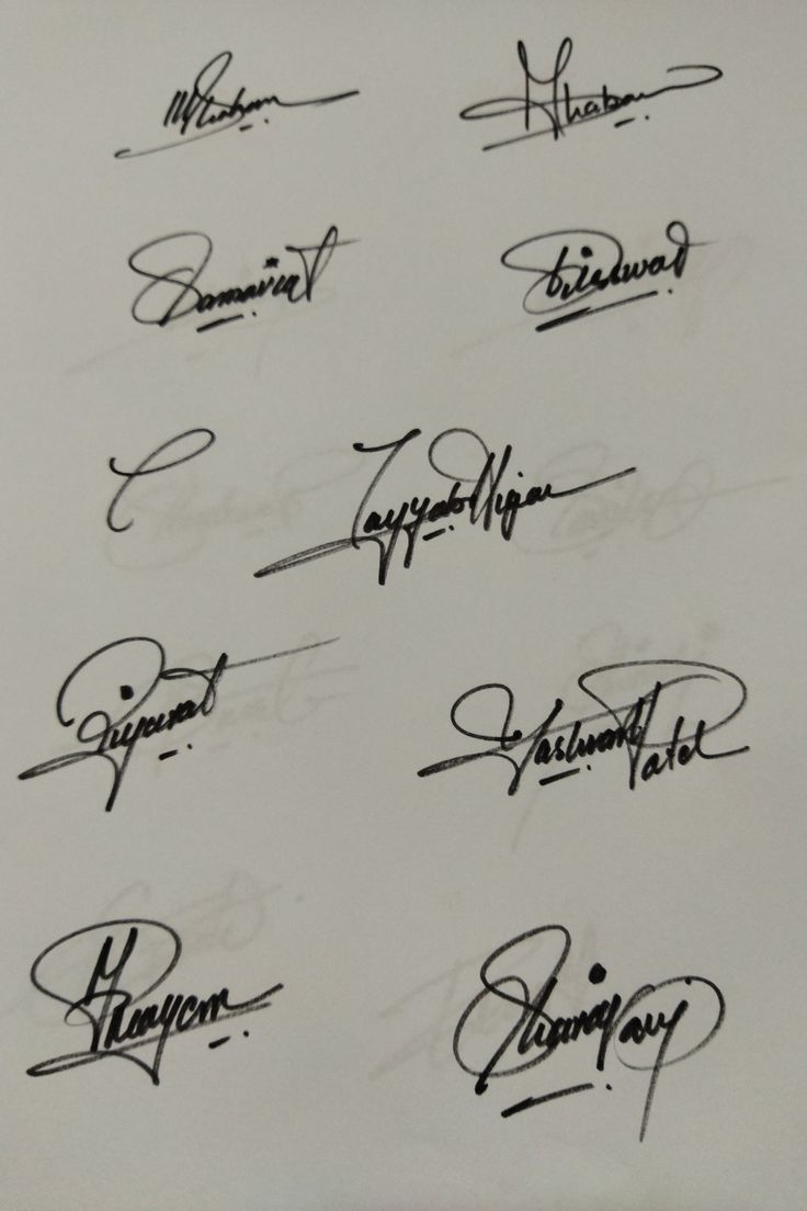 some signed autographs are shown on a sheet of paper