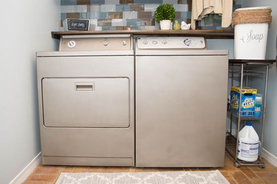 a washer and dryer sitting next to each other in a room with blue walls