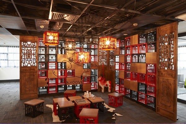 a room filled with lots of windows and wooden shelves covered in red glass cases on the walls