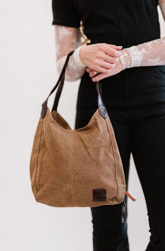 our anniston hobo bag is as cute as it is functional. it comes with two magnetic-snap compartments on top of each side of the main zipper-enclosed compartment. this makes it a breeze to throw in your phone or keys that you might need quick and easy access to, while still being able to zip up your wallet or cash in a more concealed and safe compartment. you're going to love the size of this bag too. it's big enough to store your necessities, but you'll never feel like you're carrying around a bul Canvas Hobo Bag, Daily Essentials, Modern Chic, Hobo Bag, Leather Handle, Easy Access, Zipper Pocket, Final Sale, Vegan Leather