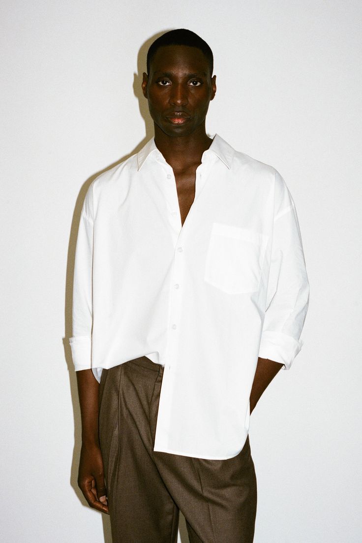 An ultra-crisp button up shirt with the effortless proportions of 90's Wall Street. Worn untucked or half-tucked, this oversized, billowy office staple makes for the ultimate off-duty move. Constructed from 100% pima cotton, a superior high-grade cotton known for it's incredible softness. Modern Oversized Button-up Tops, Classic Oversized Tops For Workwear, Everyday Dress Shirt With Relaxed Fit And Long Sleeves, Relaxed Fit Long Sleeve Dress Shirt For Everyday, Everyday Relaxed Fit Long Sleeve Dress Shirt, Oversized Classic Tops For Business Casual, Modern Oversized Collared Shirt, Modern Oversized Shirt For Office, Relaxed Fit Dress Shirt For Summer Daywear