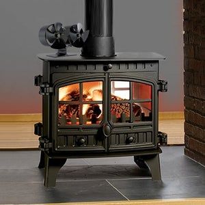 a black stove sitting on top of a hard wood floor