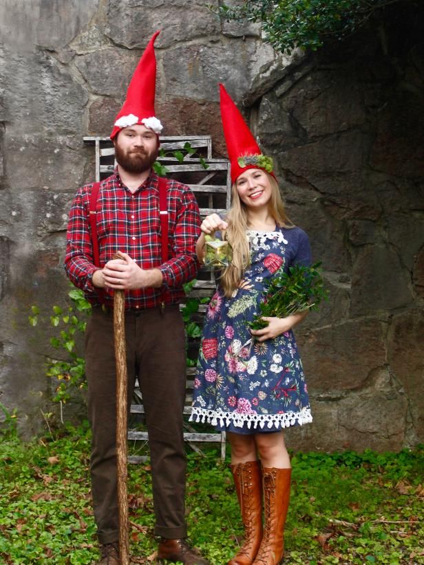 two people dressed up as gnomes standing next to each other