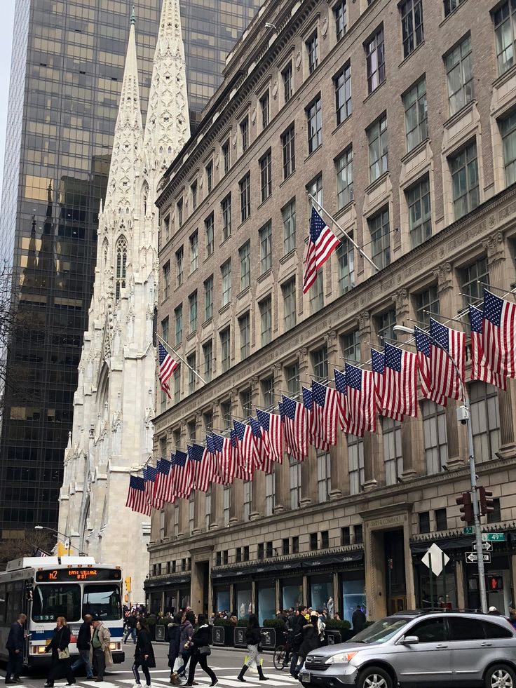 many american flags are flying in the city