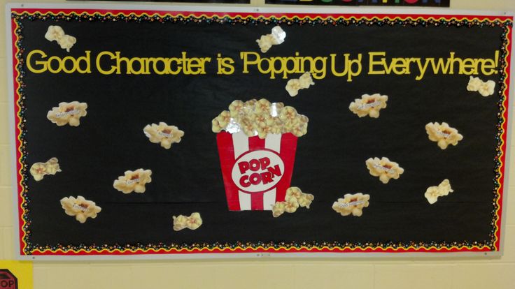 a bulletin board with popcorn on it that says good character is pooping up everywhere