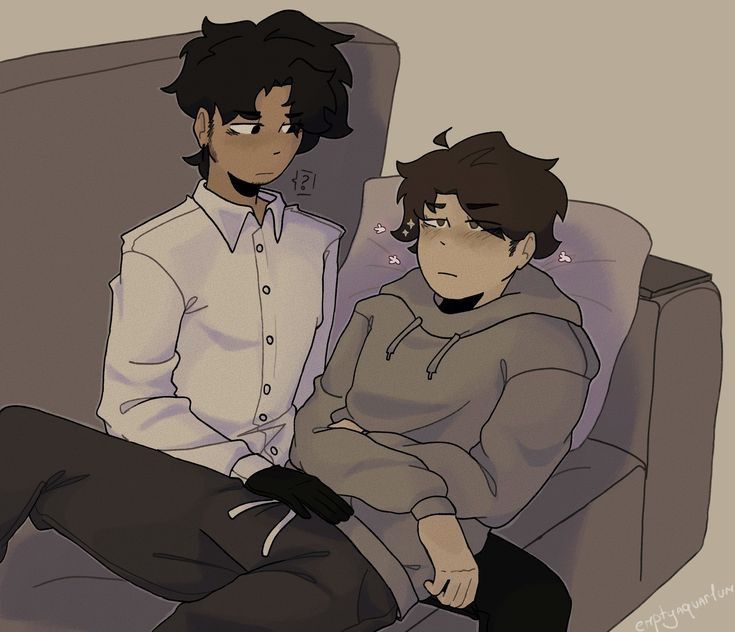 two people sitting on a couch with one person wearing a sweater