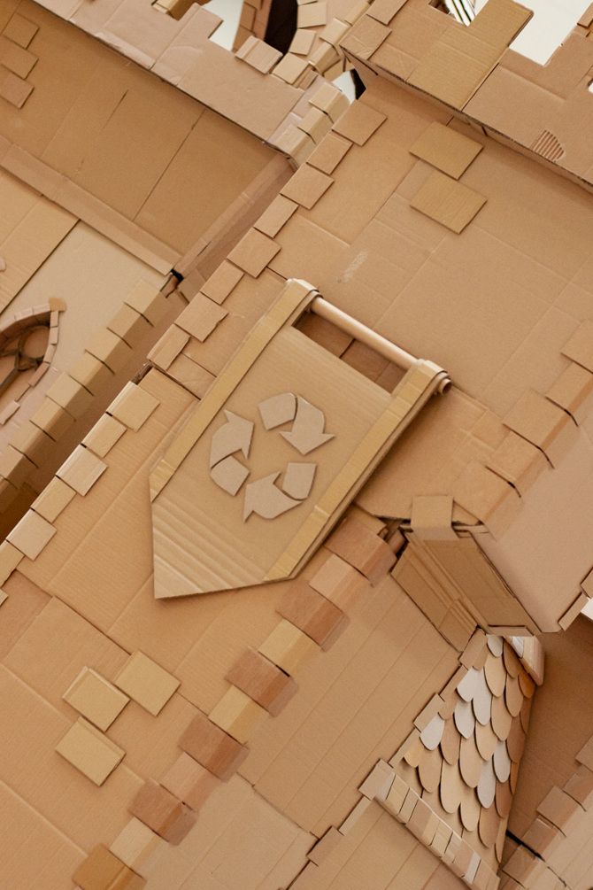 a cardboard castle made to look like it has a clock