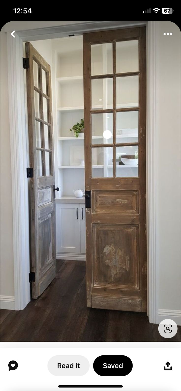 an open wooden door sitting inside of a room