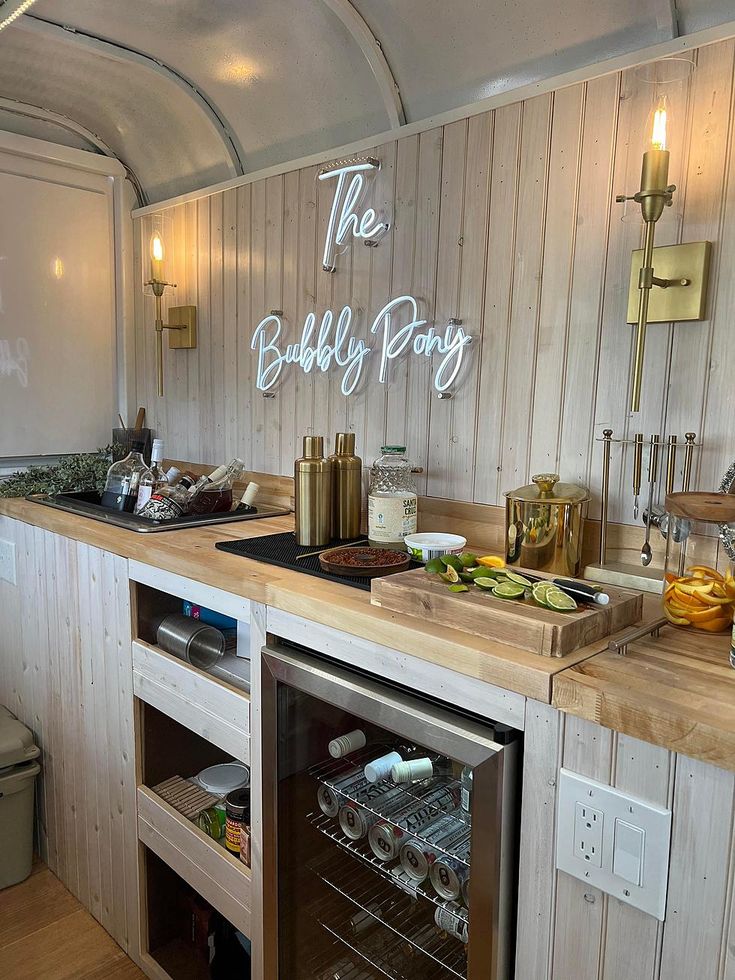 a kitchen area with an oven, refrigerator and counter top that has the words the bubbly pony written on it