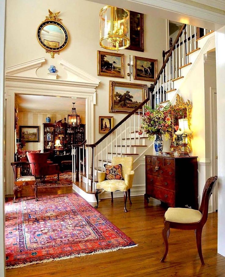 a room with a staircase and pictures on the wall