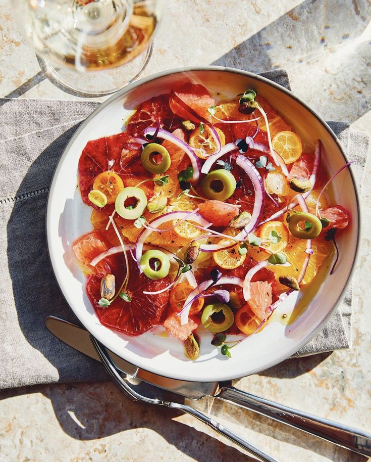 a white plate topped with red onions and olives