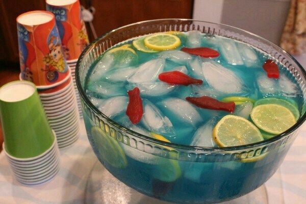 a bowl filled with ice and lemon slices on top of a table