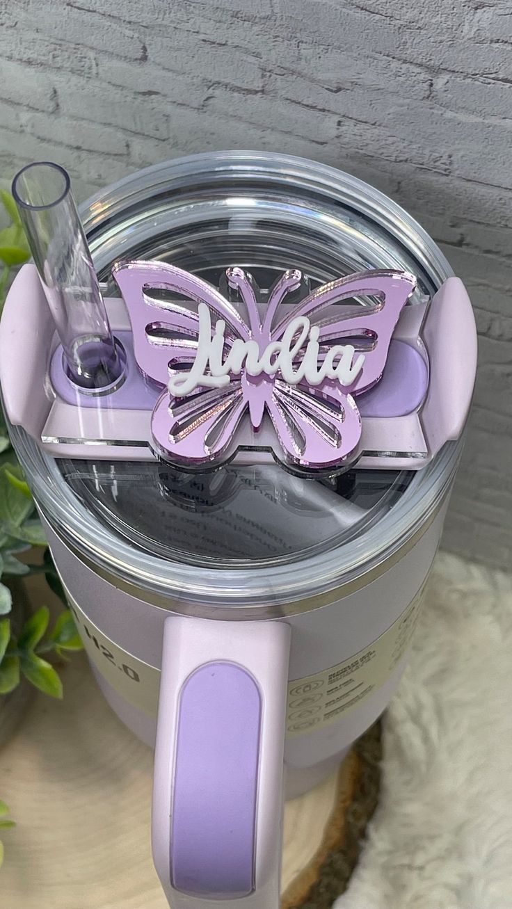 an electric blender sitting on top of a table next to a potted plant