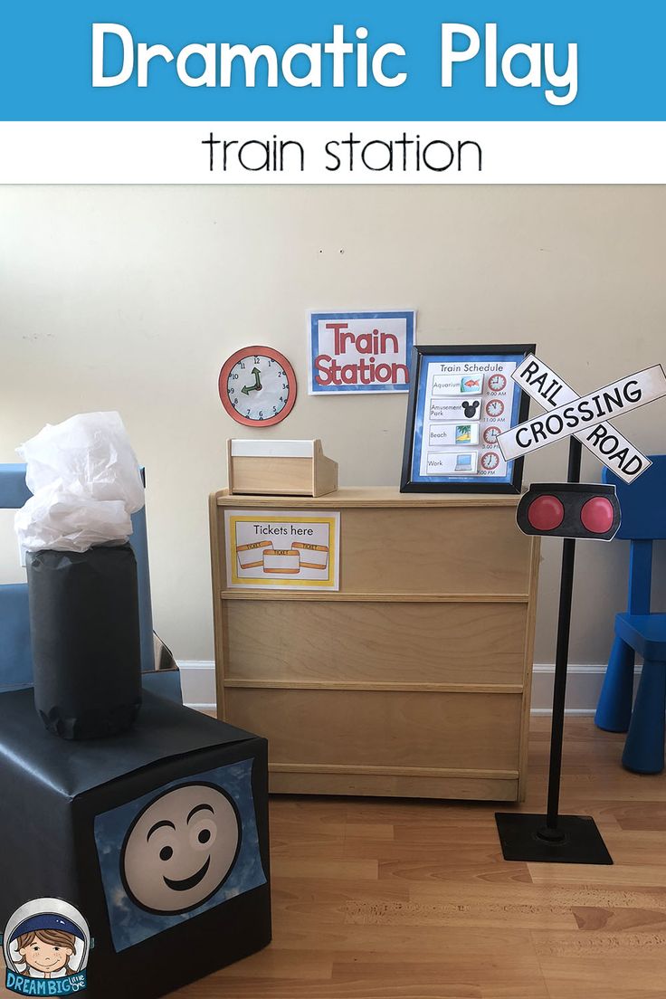 there is a train station on the floor in this child's playroom with toys