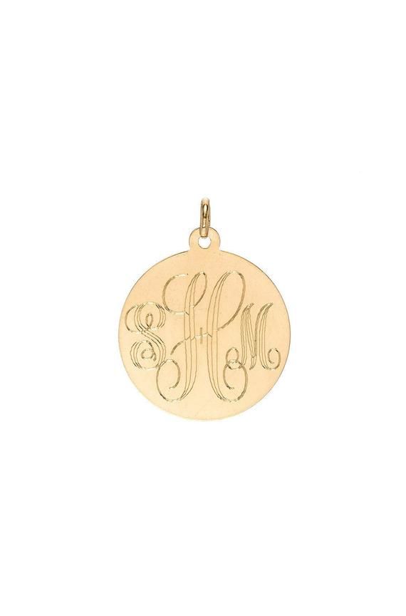 14k solid gold engraved large disc pendant charm in a script font in the gold color of your choice (pendant only, does not include chain) wear it by itself or stacked with the charms of your choice, with your initial or your loved ones.Made in L.A.Size of disc: Approx. 0.75''(H) by 0.75''(W) Ships in 4-7 business daysComes gift readyAll personalized items are Final Sale Engraved 14k Gold Medallion Charms, Engraved Yellow Gold Medallion Charms, Personalized 14k Yellow Gold Charms, Gold Monogram Charms For Gifts, Personalized Gold Round Pendant Charms, Personalized Yellow Gold Pendant Charms, Personalized 14k Gold Charms, 14k Gold Engraved Medallion Charms, Yellow Gold Engraved Pendant Charms