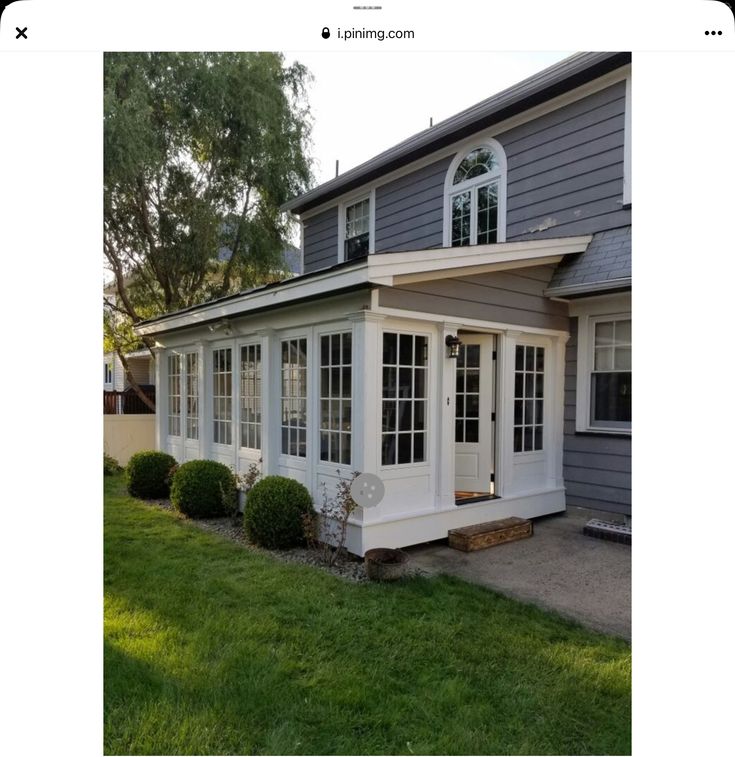 a gray house with white trim and windows