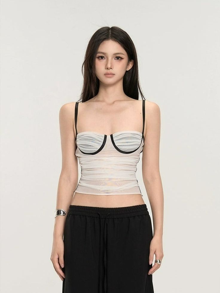 Embrace the mix of simplicity and allure with our Ruched Bustier Crop Top with Slim Straps. Its fitted silhouette and structured design offer a chic street-style edge. Crafted with a focus on texture, this crop top features delicate ruching that accentuates your shape, while the solid color design maintains a versatile and sophisticated look. The slim straps and bustier-style bodice are not just design elements; they provide support and enable a fit that's both flattering and comfortable. Whethe Chic Cropped Tube Top With Boned Bodice, Chic Summer Crop Top With Boned Bodice, Chic Boned Bodice Crop Top For Summer, Chic Fitted Tank Top With Boned Bodice, Chic Tops With Medium Bust Support, Trendy Summer Tops With Boned Bodice, Chic Tops With Boned Bodice And Spaghetti Straps, Chic Fitted Tube Top With Straps, Chic Fitted Tank Top With Removable Bra Pads