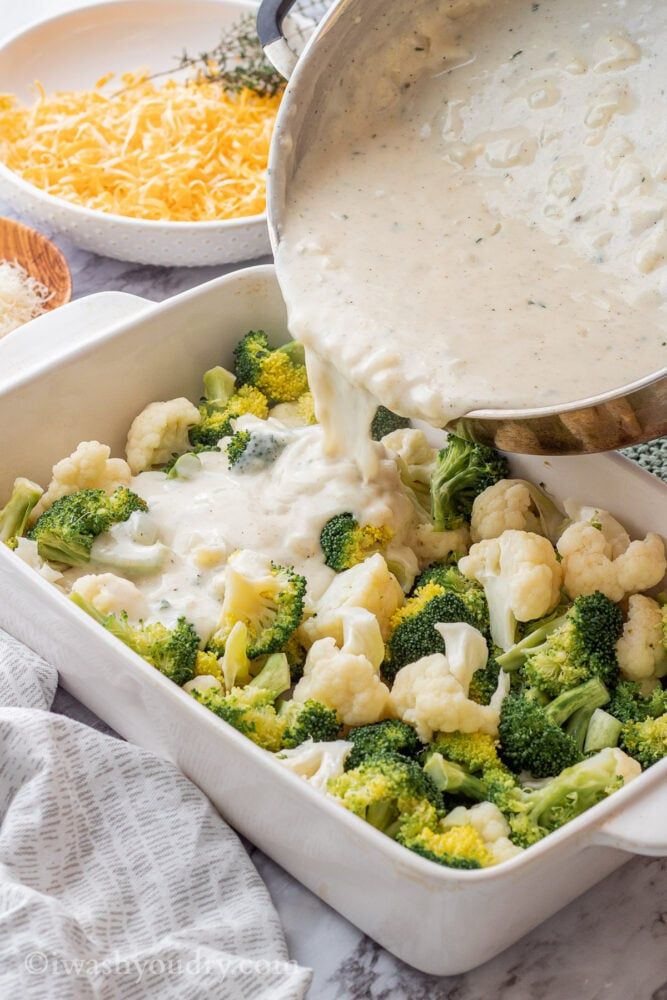 broccoli and cauliflower being poured into a casserole dish