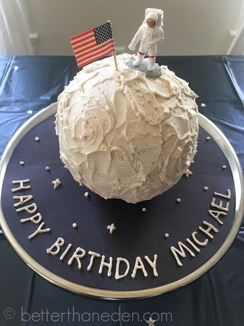 a birthday cake for michael the spaceman on top of a table with an american flag