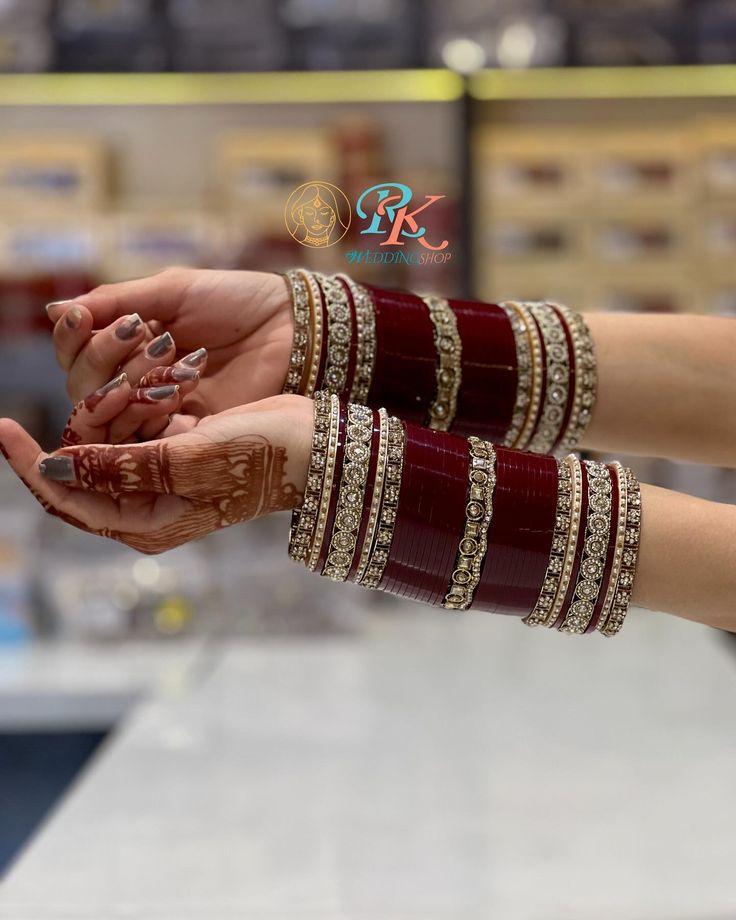 two hands holding each other with bracelets on them