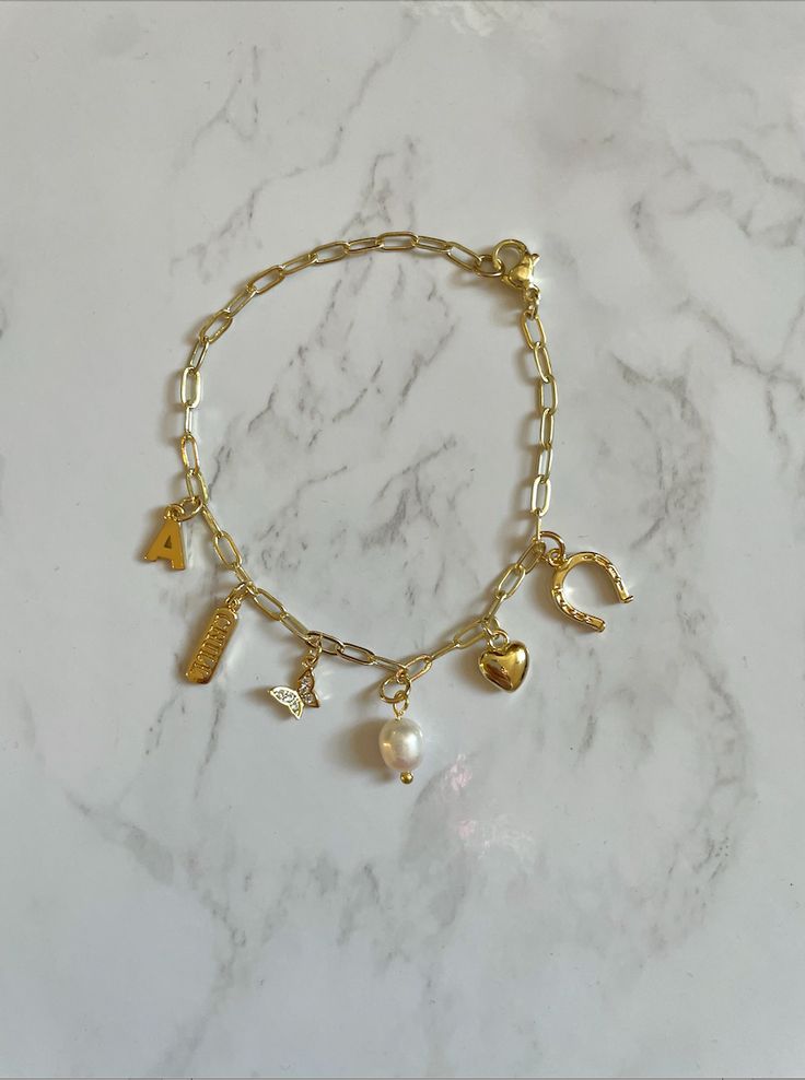 THIS IS A PRE-ORDER ITEM! Because this bracelet is custom-made, the processing time is 2 to 4 weeks before shipment. This is in addition to your selected shipment time at checkout. —————— ‣ 14k gold plated paper clip chain + gold filled charms ‣ You MUST choose the charms other you want! The bracelet does not automatically come with any charms! Charm Necklace Diy, Custom Charm Necklaces, Jewelry Accessories Ideas, Gold Charm Bracelet, Jewelry Essentials, Business Idea, Stacked Jewelry, Jewelry Lookbook, Chain Gold