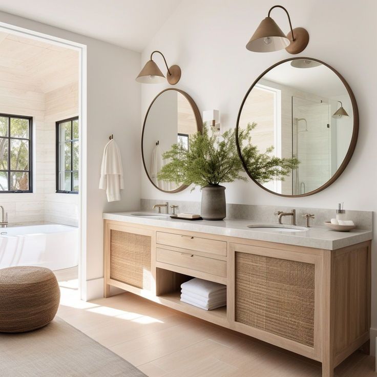 a bathroom with two sinks, mirrors and a bathtub in the middle of it