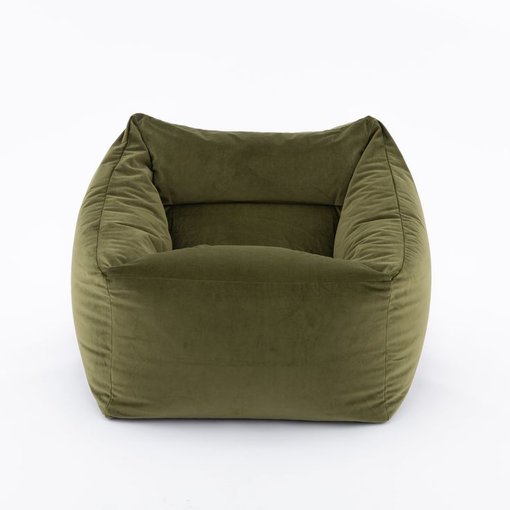 a green bean bag chair sitting on top of a white floor