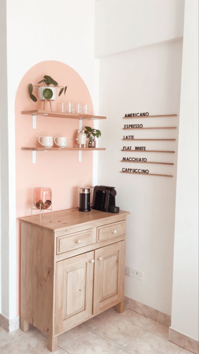 a wooden cabinet sitting next to a wall filled with pots and glasses on top of it