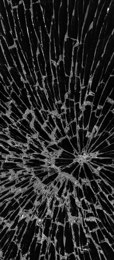 a cracked glass window that is black and white