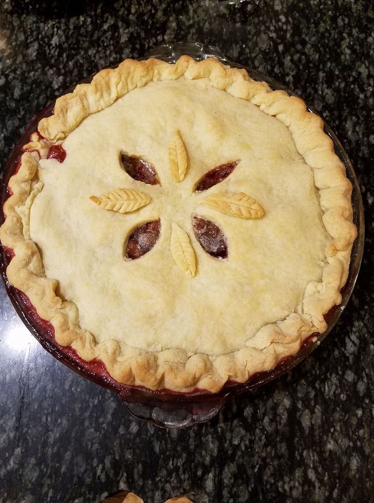 a pie sitting on top of a black counter