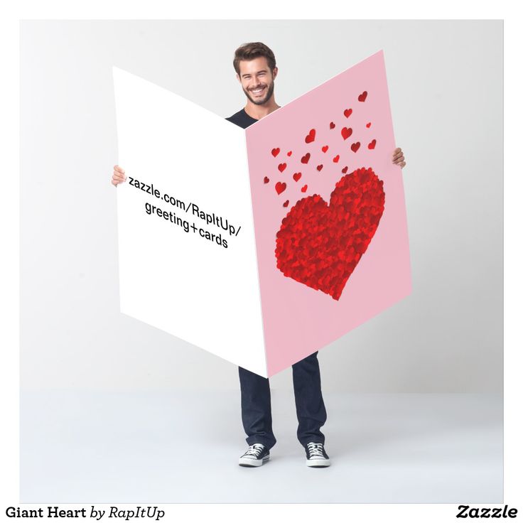 a man holding a sign with hearts on it